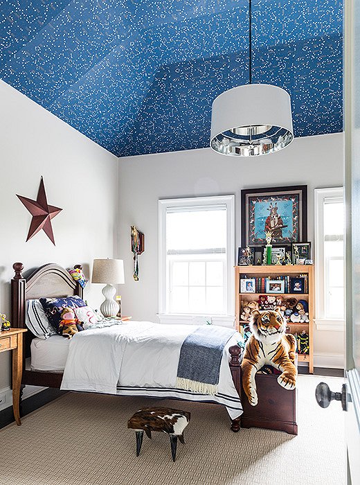The celestial wallpaper in this bedroom adds pattern while complementing the serene white walls. Find a similar starry wallpaper here. Photo by Lesley Unruh.
